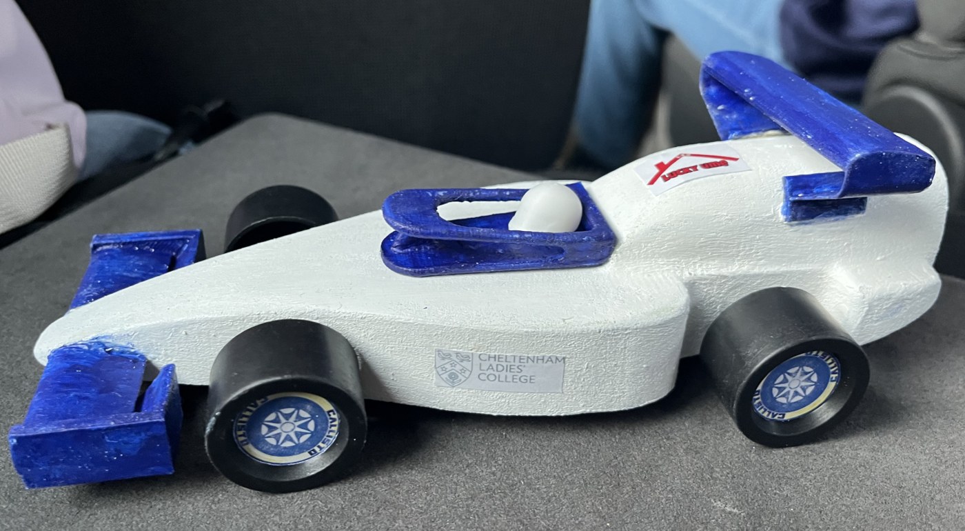 Side view of an earlier Callisto Racing car, showing the body, wheels and blue wings
