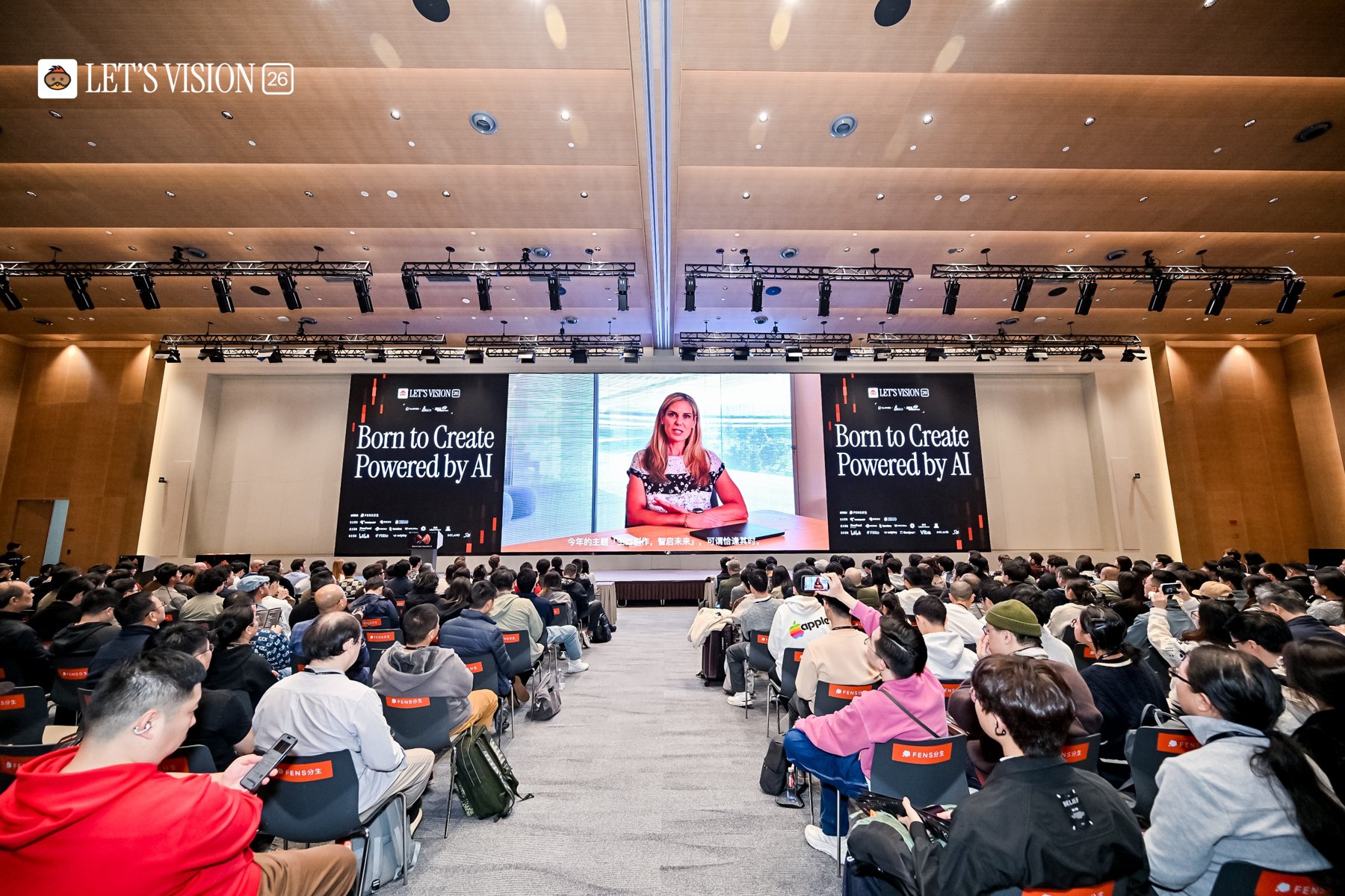A full conference auditorium at Let’s Vision, with a speaker on the main stage